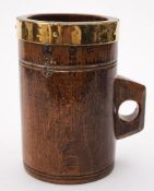 A 19th century treen and brass bound dry measure: with shaped handle,