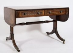 A Regency mahogany, inlaid and brass mounted sofa table:, bordered with boxwood lines,