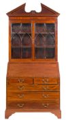 A mahogany and inlaid bureau bookcase:, in the Georgian taste, bordered with boxwood lines,