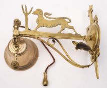 A brass hanging hall bell: mounted on a shaped backplate having a scrolling suspension arm mounted