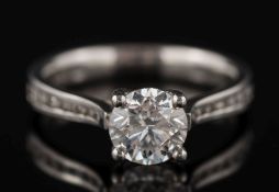 A platinum and diamond single-stone ring: with circular,