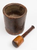A late 18th/early 19th century treen pestle and mortar: of plain cylindrical form, 24cm. high, 22cm.
