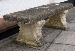 A pair of 'stone' garden benches:, the seats with moulded edge, the supports with scrollwork,
