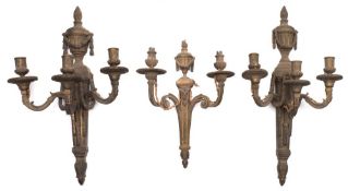 A pair of gilt metal three-branch wall lights: each backplate with flaming urn and garland