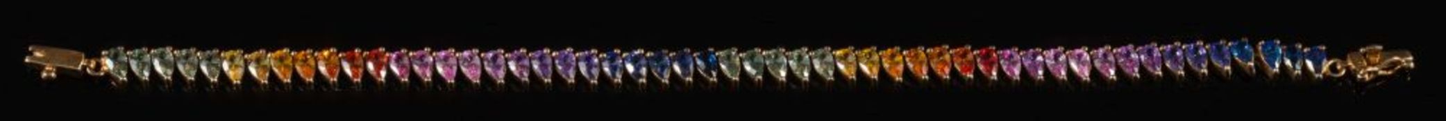 A 9ct gold and multi coloured sapphire line bracelet: of linked pear-shaped sapphires of various