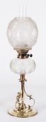 An Arts and Crafts influence brass oil lamp: with Palmer & Co, Duplex wick holder,