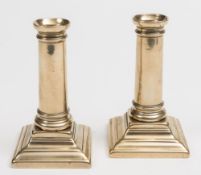 A pair of late 18th century Paktong desk candlesticks: with plain ring turned stems on stepped