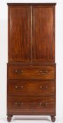 An early 19th Century mahogany cabinet on chest:,