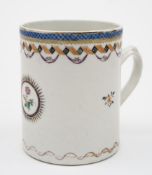 A Chinese porcelain mug: painted with a floral spray within a 'sunburst' medallion,