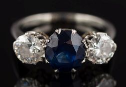 A sapphire and diamond mounted three-stone ring: with central sapphire approximately 2.