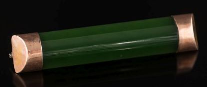 A jade and gold mounted bar brooch: 53mm long, 7.6gms gross weight.