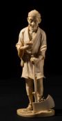 A Japanese carved ivory okimono of a sullen peasant : holding a bird's nest in one hand and an axe