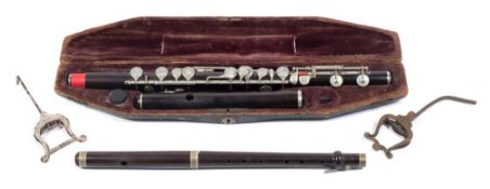 A late 19th /early 20th century rosewood and silver plated flute and similar piccolo by Butler of