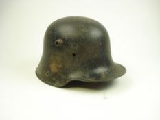 A German M1916 Stahlhelm shell:, lacking liner, stamped 'G62' to interior.