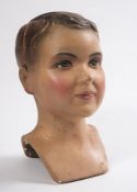 An early 20th century plaster advertising bust or mannequin head of a young boy, circa 1930s:,