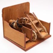 An early 20th century child's hide covered pull-along horse: on wood base with cast metal wheels,