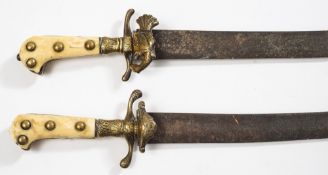 A matched pair of 19th century Continental ivory handled hunting hangers:,