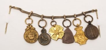 A group of six Belgian miniature medals on gilt chain and pin:,Leopold II commemorative 1865-1905,