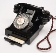 A black bakelite 312 series dial telephone:, with 'call exchange' button ,