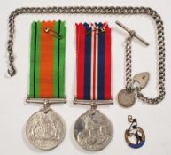 A WWI pair together with a silver watch albert chain with fobs:.