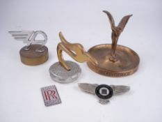 A Rolls-Royce gilt 'Spirit of Ecstasy' ashtray for RROC Newport '89, two Rolls-Royce car badges,