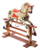 A Collinson child's rocking horse: the dapple painted horse with flared nostrils and open mouth,