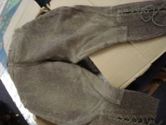 A pair of jodhpurs: and a pair of riding boots.