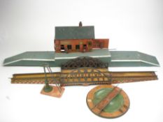 A three section lithograph printed tinplate station by Bing, Germany:, together with a turntable,