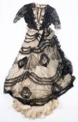 An early 20th century lady's black and white silk and lacework blouse and skirt:,