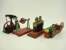 A Mamod live steam single piston stationary engine together with a four point flywheel by Mamod,