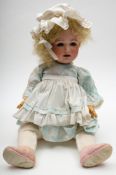 A German bisque headed character doll:, having blue glass eyes and later blond wig,
