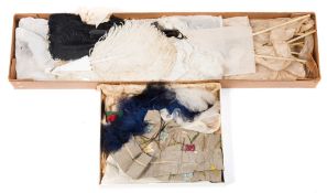 A black Ostrich feather fan together with a white example and a group of unused large Ostrich