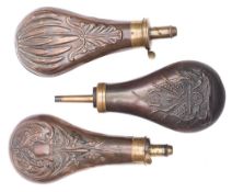 A copper and brass powder flask with American militia decoration and two other copper and brass