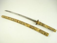 A Japanese short sword with carved bone handle and scabbard:, decorated in the traditional taste,