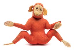 A mid-20th century red felt monkey:, with stitched eyes, nose and mouth and outstretched limbs,
