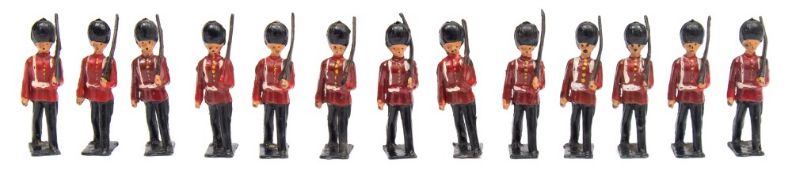 A set of thirteen marching Guardsmen:, unsigned, in an associated Britains Infantry box.