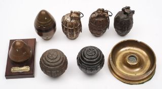 A group of five deactivated Mills' bombs: also a pair of shell fuses,