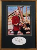 Michael Caine- a black ink autograph framed and mounted together with a photograph in costume from