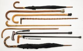 Two silver mounted antler handled walking canes together with a collection of various other canes