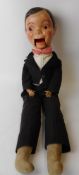 A 1930s papier mache ventriloquist's dummy: as a gentleman with pink bow tie, white shirt and tails,