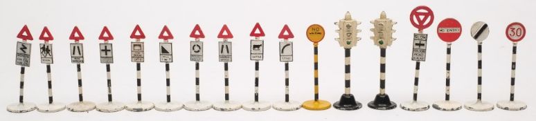 A group of seventeen Dinky road signs:, including two sets of four way traffic lights.