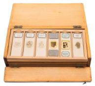 A pine slide case containing thirty five mineral specimens in six trays:, by Hensoldt and others.