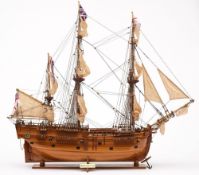 A scale model of HMS Endeavour:, fully rigged and set sails over deck with fixture and fittings,