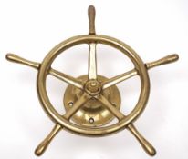 A small brass ship's helm:, on a brass mount, 39cm diameter.