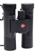 A pair of Leica 'Ultravid' compact binoculars in black travel bag:.