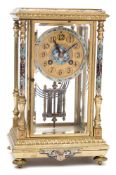 An enamelled four-glass mantel clock: the eight-day duration movement striking the hours and
