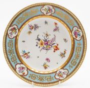 A Vienna porcelain plate: painted with scattered floral sprays and sprigs within a gilded pale blue