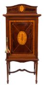 An Edwardian mahogany and inlaid music cabinet: crossbanded in satinwood,