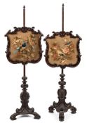 A pair of Victorian carved rosewood polescreens:, with acorn finials,