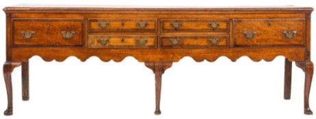 An 18th Century oak and crossbanded rectangular dresser base:, the top with a moulded edge,